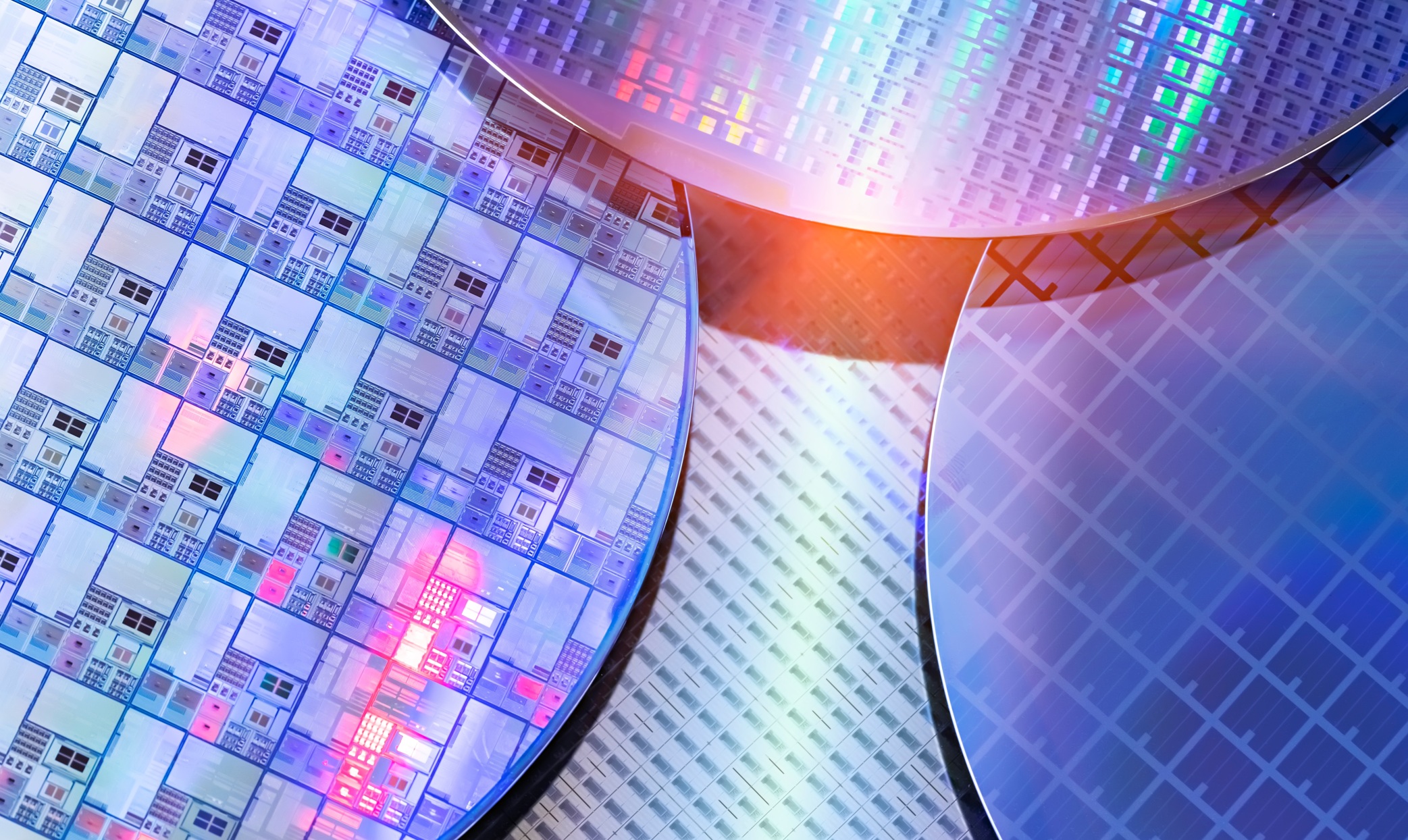 Semiconductor Collaboration — close-up of silicon wafers showing circuit patterns