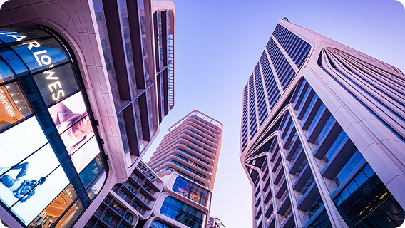 Modern high-rise towers in Malta seen from below against a clear sky